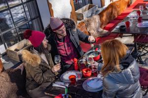 a group of people sitting at a table with wine glasses at Le Coucou Hotel Restaurant & Lounge-Bar in Montreux