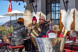 a group of people sitting at a table with wine glasses at Le Coucou Hotel Restaurant & Lounge-Bar in Montreux