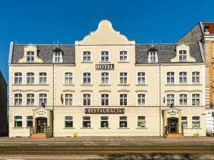 a large white building with a hotel on a street at Hotel Sowa in Elblag