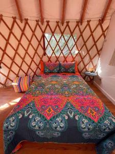 a bedroom with a bed in a yurt at Heated & AC Yurt in Penn Yan