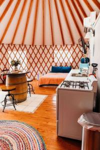 a yurt with a stove and a stove top at Heated & AC Yurt in Penn Yan