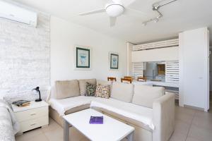 a living room with a couch and a table at AMAZING SEASIGHTS - TENERIFE in Costa Del Silencio