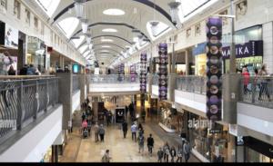 an overhead view of a shopping mall with people in it at Bluebell Cottage - private coach house, garage & parking in Greenhithe