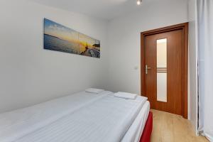 Posteľ alebo postele v izbe v ubytovaní Apartament George