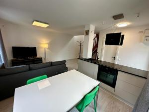 a living room with a white table and a couch at Complex Casa Buna Vestire in Ploieşti