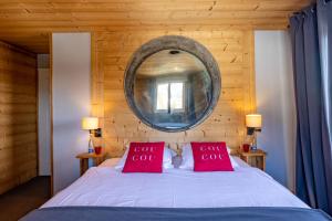 a bedroom with a bed with two red pillows at Le Coucou Hotel Restaurant & Lounge-Bar in Montreux