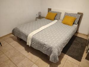 a bedroom with a large bed with yellow pillows at Guesthouse Suzy in Pula