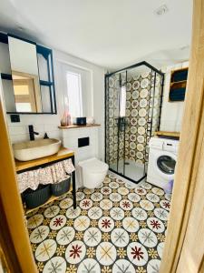 a bathroom with a sink and a toilet and a shower at Domek TRZY BABY in Dołgie