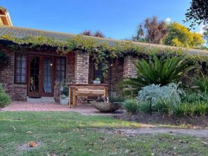 a brick house with a table in front of it at Place of Sonlight in Swellendam