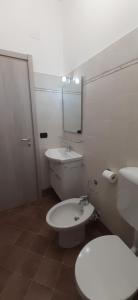 a bathroom with a white toilet and a sink at CASA PRIMAVERA in Vado Ligure +12 photos