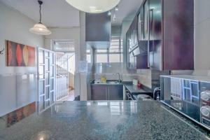 a large kitchen with a counter top in a room at Marlborough apartment 509 in Durban