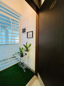 a hallway with two potted plants on a balcony at The Hill Regency in Bentong