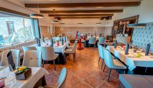 a restaurant with tables and chairs in a room at Guesthouse Dolinsek in Sevnica