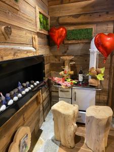 a kitchen with wooden walls and hearts on the wall at URBAN PIC NIC in Piazza Brembana