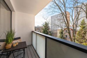 a balcony with two chairs and a view of a city at Thomas Apartament SOPOT in Sopot