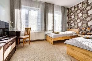 Posteľ alebo postele v izbe v ubytovaní Hotel Sowa