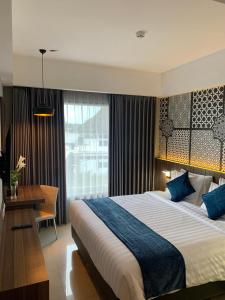 Ένα ή περισσότερα κρεβάτια σε δωμάτιο στο Unisi Hotel Malioboro - Jogja Syariah