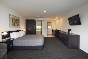 una camera d'albergo con letto e divano di Pavilions Hotel a Christchurch