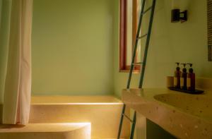 a bathroom with a tub and a sink and a shower at Ecosfera Hotel & Spa in Canggu