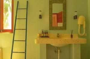 a bathroom with a sink and a mirror at Ecosfera Hotel & Spa in Canggu