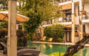 a swimming pool in front of a building at Ecosfera Hotel & Spa in Canggu