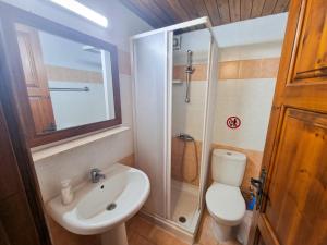 a bathroom with a toilet and a sink and a shower at Poseidon's Pool Paradise in Skarinou