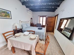 a bedroom with a bed and a table and chairs at Poseidon's Pool Paradise in Skarinou