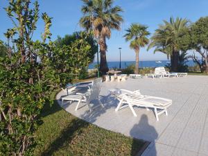 - un ensemble de chaises et de tables blanches sur une terrasse dans l'établissement Puerto Tomas Maestre, à San Javier