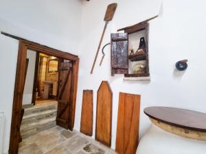 a room with wooden doors and a table on a wall at Poseidon's Pool Paradise in Skarinou