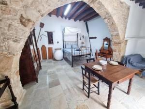 a living room with a table and a bedroom at Poseidon's Pool Paradise in Skarinou