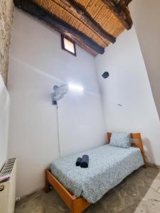a bedroom with a bed in a white wall at Poseidon's Pool Paradise in Skarinou