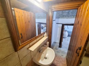 a bathroom with a sink and a mirror at Poseidon's Pool Paradise in Skarinou