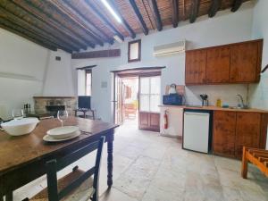 a large kitchen with a table and a counter top at Poseidon's Pool Paradise in Skarinou