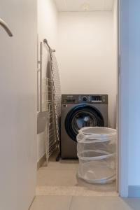 a washing machine in a laundry room with a washer at Cozy and Spacious l Big Terrace in Dubai