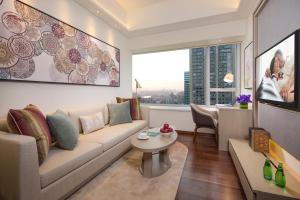 a living room with a couch and a table at Ascott Macau in Macau