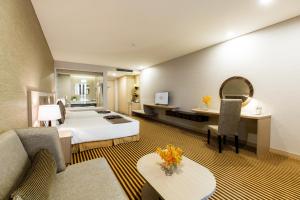 a hotel room with a bed and a desk at Muong Thanh Luxury Khanh Hoa in Nha Trang