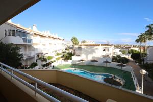 a view from the balcony of a building with a swimming pool at 2 bedroom apartment at beach Dehesa de Campoamor in Dehesa de Campoamor