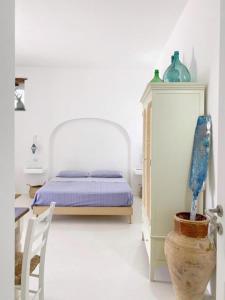 a bedroom with a bed and a table and a chair at Agata B&B in Lipari