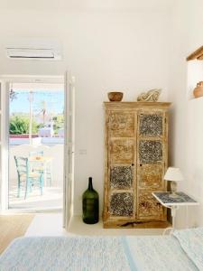 a room with a wooden cabinet with a bottle of wine at Agata B&B in Lipari