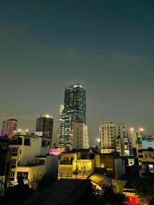 a city skyline with tall buildings at night at Anh Thien Sai Gon Central Hotel - by Bay Luxury in Ho Chi Minh City