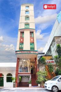 a tall building with a car parked in front of it at Anh Thien Sai Gon Central Hotel - by Bay Luxury in Ho Chi Minh City