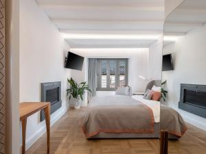 a bedroom with a bed and a tv at Ionas Boutique Hotel in Chania