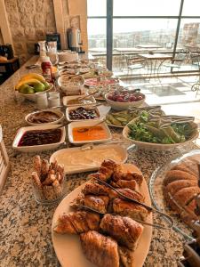 a buffet of food on a table with plates of food at Vita Cave Suites in Ürgüp