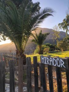 a wooden fence with a sign on it at Cortijo Pulgarín Bajo in Alfarnatejo