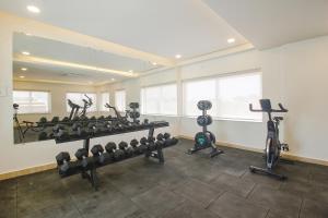 a gym with several treadmills and exercise bikes at Western Suites HiTech City in Hyderabad