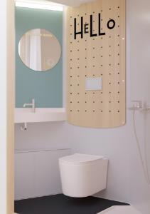 a bathroom with a hello sign above a toilet at Premiere Classe Marseille Vitrolles Aéroport in Vitrolles