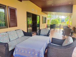 a living room with a couch and chairs and a patio at Seabreeze 145 by malai in Rayong