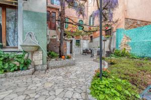 a stone walkway in front of a building at Hotel Casa Boccassini in Venice