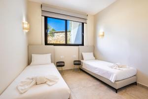 Posteľ alebo postele v izbe v ubytovaní Euphoria Suites