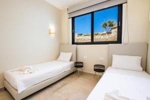 Posteľ alebo postele v izbe v ubytovaní Euphoria Suites